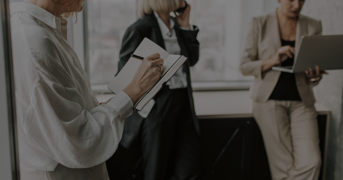 Woman at a networking event with a coffee, engaged in conversation — Up After Studios blog on business growth and networking